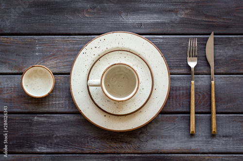 Elegant table setting with plates and tableware on wooden background top view