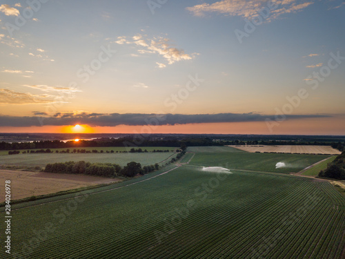 Canvas Print An aerial view of Suffolk farm fields with a sunset in the background