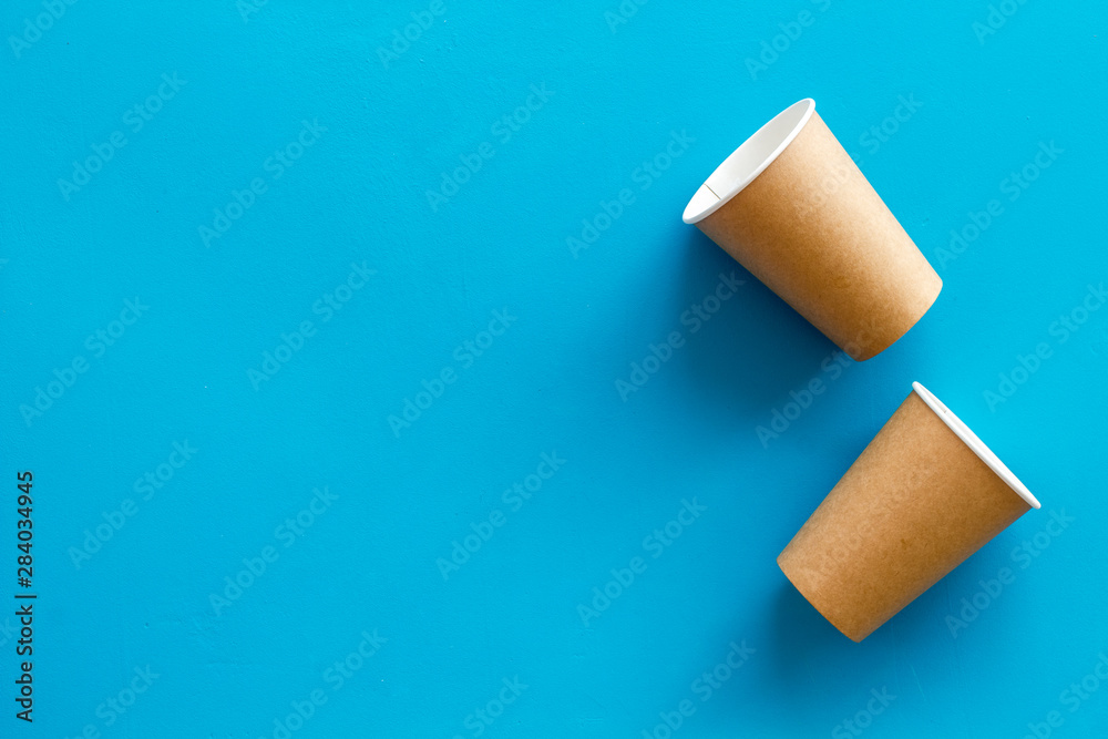 Paper cups for coffee to go on blue background top view mockup Paper cups for coffee to go on blue background top view mockup