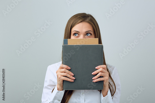 Woman hide face behind book. © Yuriy Shevtsov