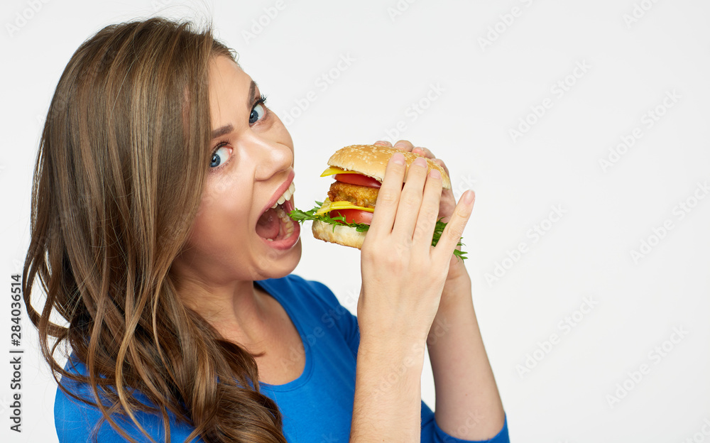 woman eating big burger. Isolated portrait. woman eating big burger. Isolated portrait.