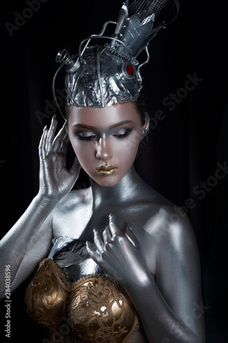 young, beautiful girl with silver skin in a crown and gold armor