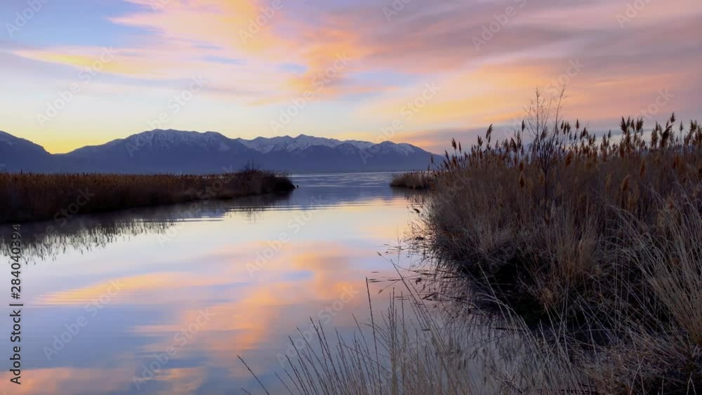 Watercolor of a river flowing into a lake at sunset transitions from animation to real life Watercolor of a river flowing into a lake at sunset transitions from animation to real life