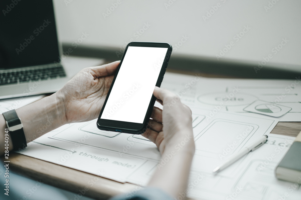 Fototapeta premium Mockup image of ux graphic designer creative smartphone application process development interface for web mobile phone, mockup concept