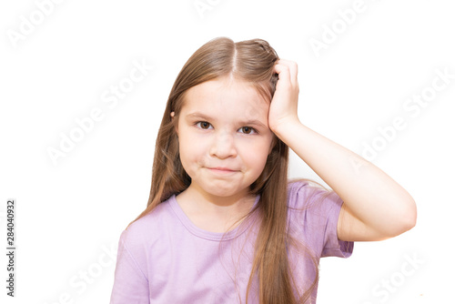 The little girl looks thoughtfully into the frame, and props her cheek with her hand. Isolated on a white background.