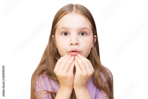 The little girl is tearfully asking, clasped hands. Isolated on a white background. photo