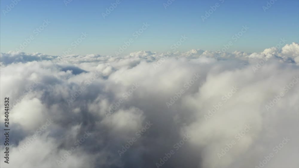 Flying above great white clouds in the morning. Aerial