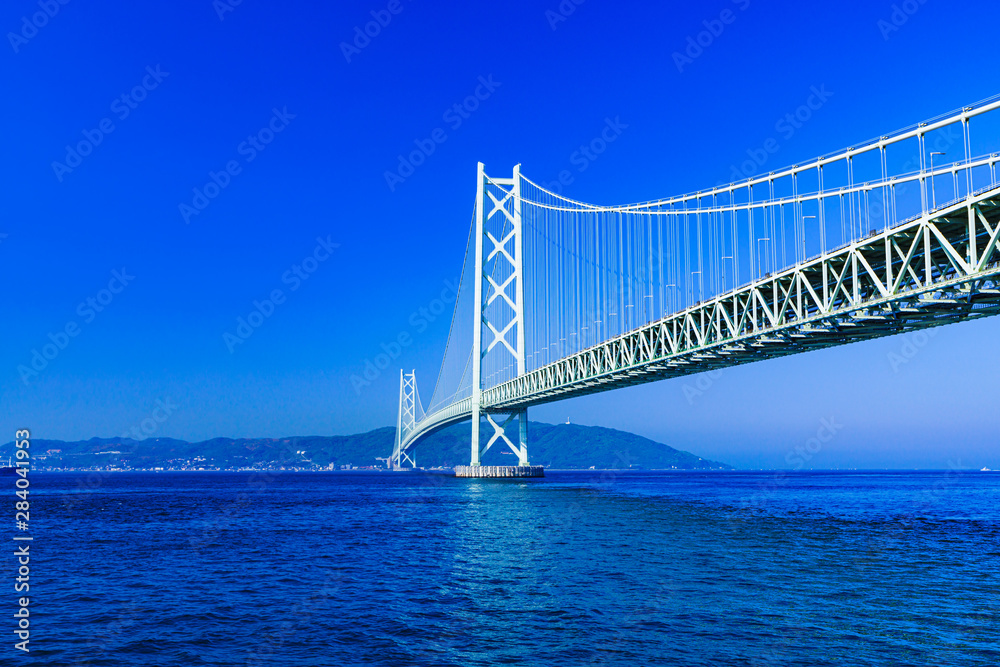 Landscape of Akashi Kaikyo Bridge in the background of blue sky in the summer morning Landscape of Akashi Kaikyo Bridge in the background of blue sky in the summer morning