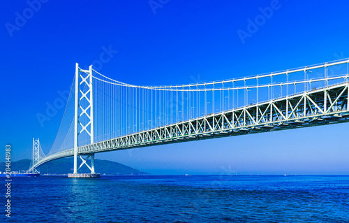 Landscape of Akashi Kaikyo Bridge in the background of blue sky in the summer morning photo