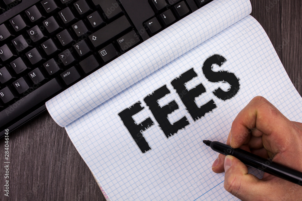 Conceptual hand writing showing Fees. Business photo text Online creative agency charges product components hourly costs written by Marker in Hand Notebook wooden background Keyboard