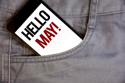 Writing note showing Hello May Motivational Call. Business photo showcasing Starting a new month April is over SpringConcept on cell phone on jean pocket white screen black and red letters photo