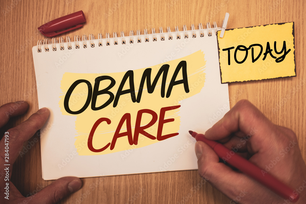 Text sign showing Obama Care. Conceptual photo Government Program of Insurance System Patient ProtectionMan creating for today on notebook Hand hold holding pen Wooden background