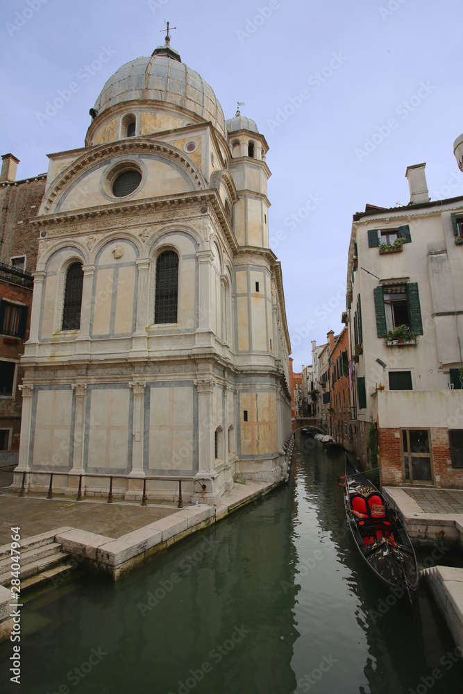 A church, canal and a gondola in Venice