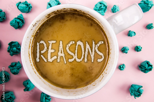 Handwriting text Reasons. Concept meaning Causes Explanations Justifications for an action or event Motivation written Coffee in White Cup within Crumpled Paper Balls plain pink background. photo