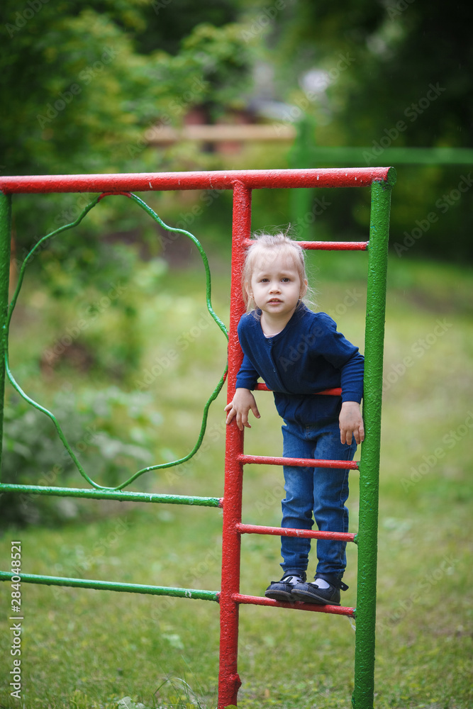 Obraz premium Cute little girl playing on the playground