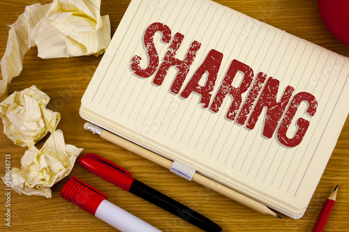 Conceptual hand writing showing Sharing. Business photo showcasing To Share Give a portion of something to another Possess in common written Notebook Book the wooden background Pen Pencil.