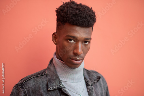 Portrait of man with serious expression against isolated background © rushay