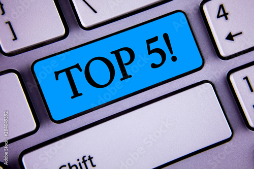 Writing note showing Top 5 Motivational Call. Business photo showcasing The best ones Winners Most Popular Bestsellers written Blue Key Button White Keyboard with copy space. Top view. photo