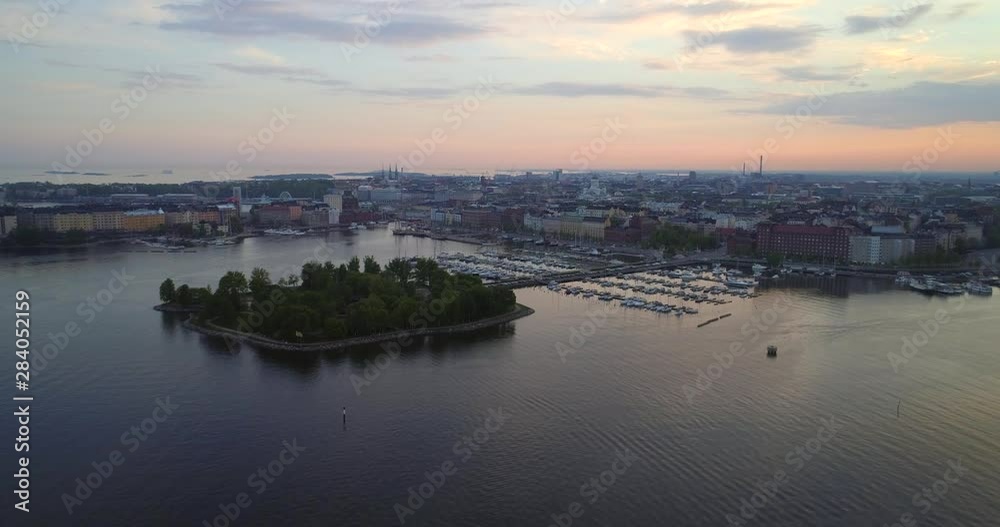 Helsinki north harbor, Aerial, rising, drone shot, overlooking the Tervasaari island, the Kruununhaka area, the cathedral and the cityscape, at dusk, on a sunny evening sunset, in Uusimaa, Finland Helsinki north harbor, Aerial, rising, drone shot, overlooking the Tervasaari island, the Kruununhaka area, the cathedral and the cityscape, at dusk, on a sunny evening sunset, in Uusimaa, Finland
