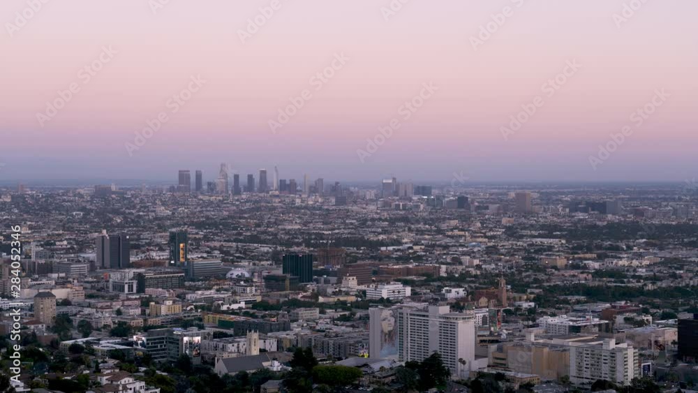 Day to Night Timelapse from high above the city of Los Angeles shot from Runyon Canyon Park. Super clear night, not a cloud in the sky, all of the city lights come up and you can see all the activity. Day to Night Timelapse from high above the city of Los Angeles shot from Runyon Canyon Park. Super clear night, not a cloud in the sky, all of the city lights come up and you can see all the activity.