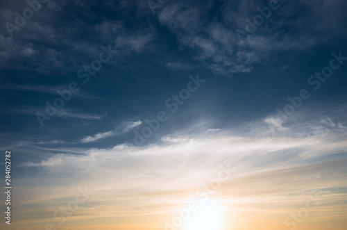 Sunset and cirrus clouds on a bright blue sky.