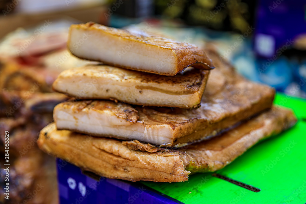 Slabs of cured and smoked pork belly fat on display at a market in Kotor Montenegro, traditional Montenegrin cuisine Slabs of cured and smoked pork belly fat on display at a market in Kotor Montenegro, traditional Montenegrin cuisine