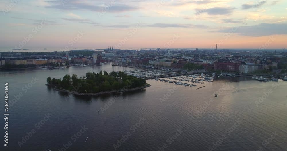 Helsinki north harbor, Aerial, descending, drone shot, of the Tervasaari island, the Kruununhaka area, the cathedral and the cityscape, at dusk, on a sunny evening sunset, in Uusimaa, Finland Helsinki north harbor, Aerial, descending, drone shot, of the Tervasaari island, the Kruununhaka area, the cathedral and the cityscape, at dusk, on a sunny evening sunset, in Uusimaa, Finland