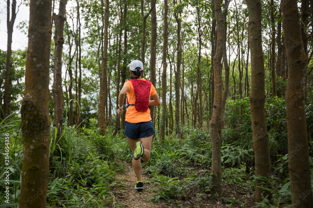 Ultramarathon runner running in tropical rainforest Ultramarathon runner running in tropical rainforest
