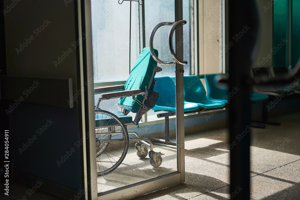 Wheelchair in empty hospital corridor with sunlit cinematic photography dark concept. Wheelchair in empty hospital corridor with sunlit cinematic photography dark concept.