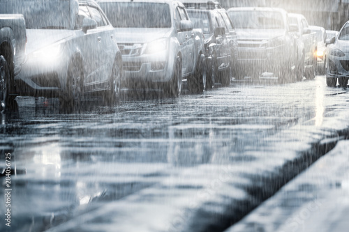 Картината върху платно Hard rain fall in the city with blurry cars .Selective focus.