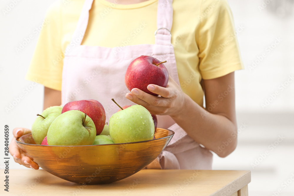 custom made wallpaper toronto digitalWoman with bowl of fresh apples at table in kitchen, closeup