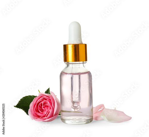 Bottle of essential oil and rose on white background