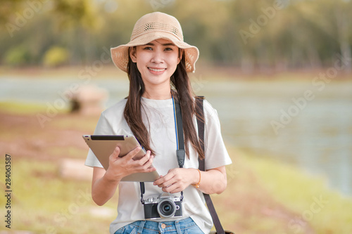 Beauty women holding tablet with camera travel take photo