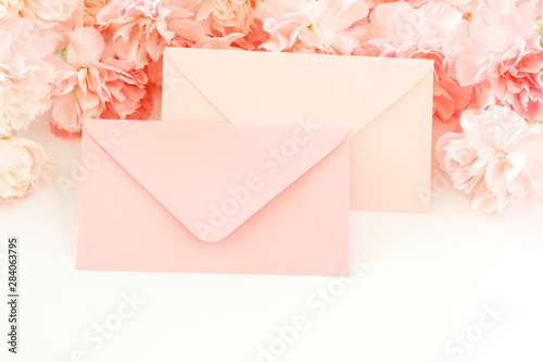 Love letters and carnation flowers, romantic decoration in pastel colors.