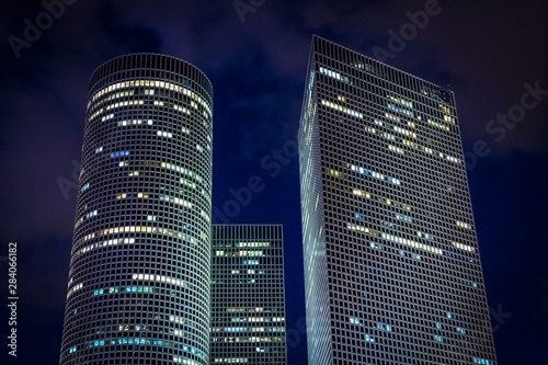 Azrieli shopping and busines center three skyscrapers in the evening on the background of night sky in Tel Aviv, Israel