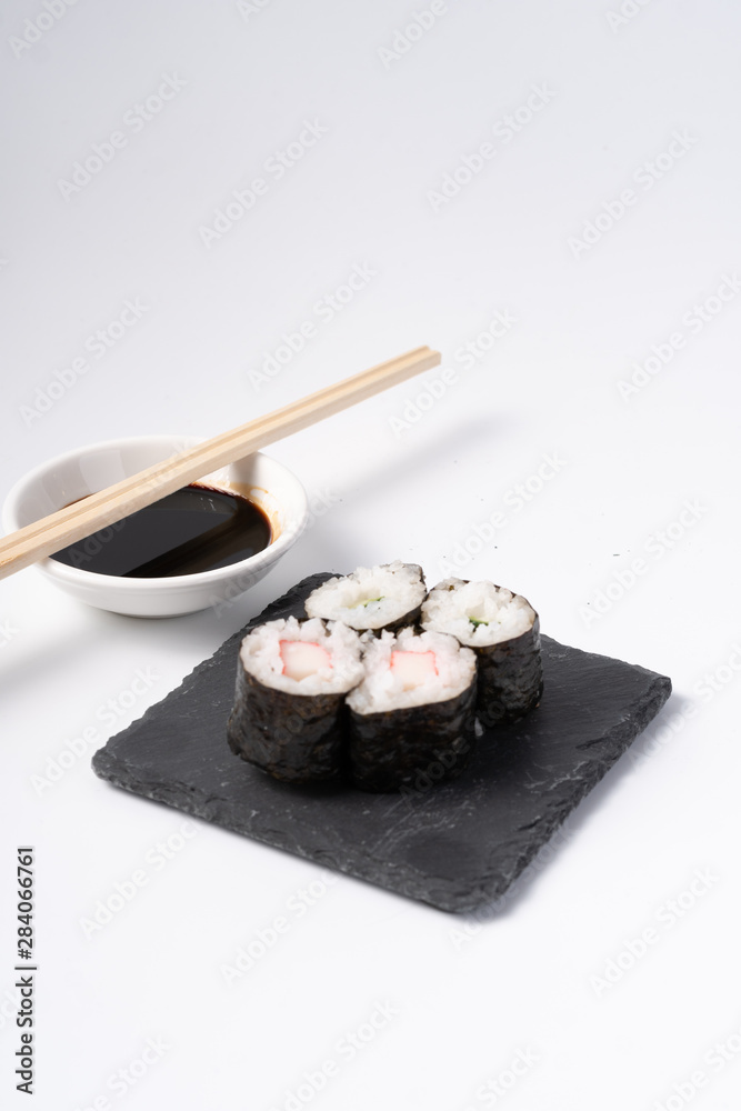 Mix sushi set, Japanese food on slate platte isolated white background Mix sushi set, Japanese food on slate platte isolated white background