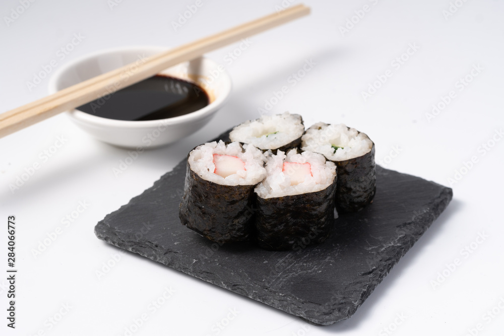 Mix sushi set, Japanese food on slate platte isolated white background Mix sushi set, Japanese food on slate platte isolated white background
