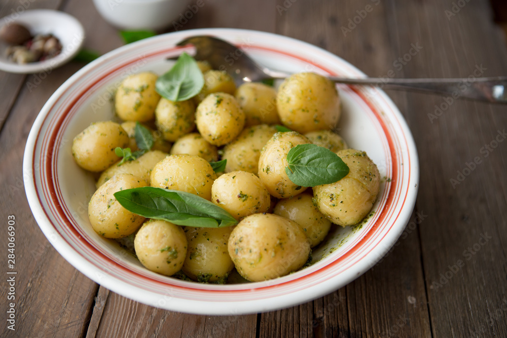 Potato. Tasty Young boiled potatoes with basil in white bowl on rustic wooden table. Potato. Tasty Young boiled potatoes with basil in white bowl on rustic wooden table.