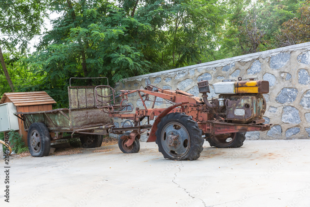 Outdoor scrapped rusty Chinese style walking tractor wreck Outdoor scrapped rusty Chinese style walking tractor wreck