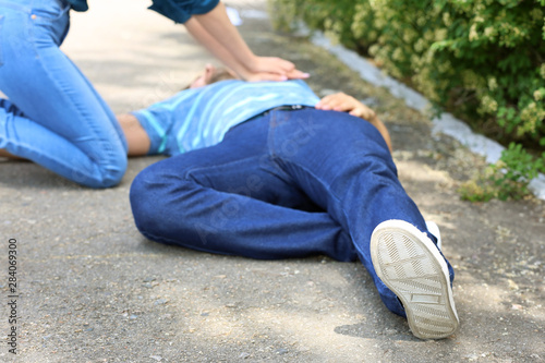 Woman giving CPR to unconsc...
