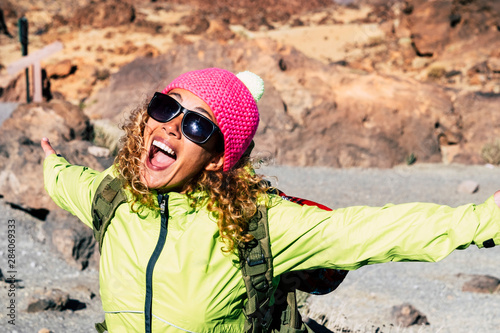 Happiness lifestyle with cheerful beautiful people caucasian young woman enjoying the outdoor leisure activity at the mountain hiking and doing sport trekking for healthy life