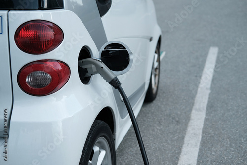 Wallpaper Mural Electric white car at charging station, Vancouver. Concept: alternative energy spread Torontodigital.ca
