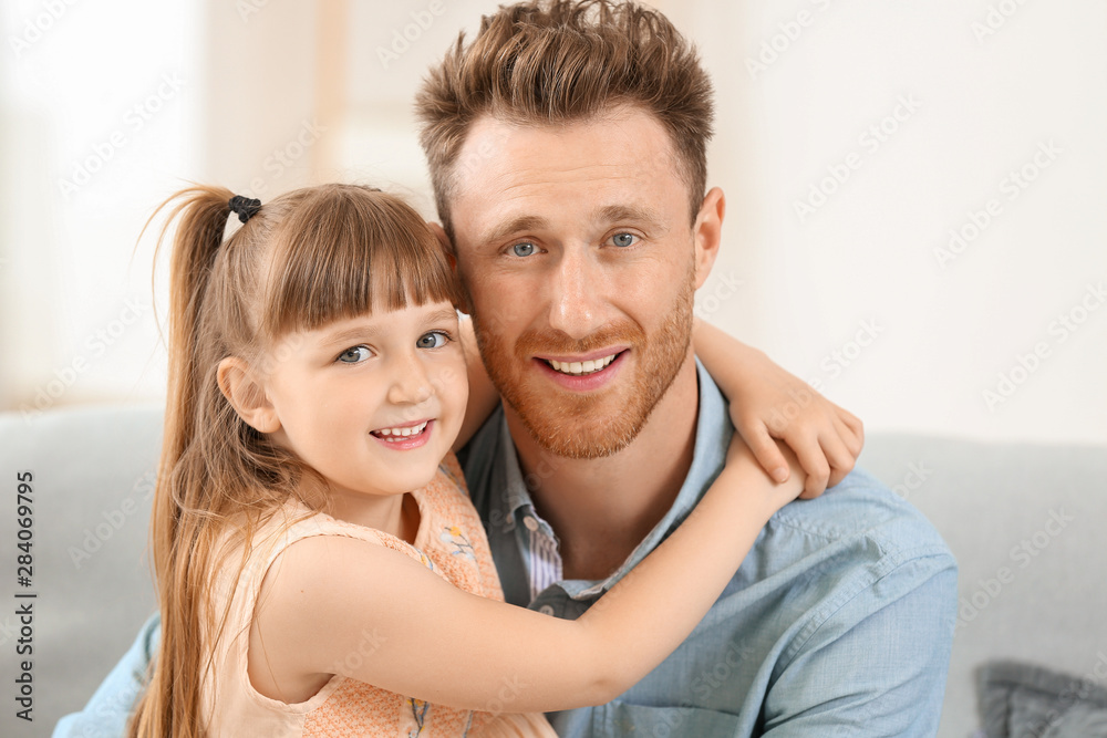 Portrait of happy father and his little daughter at home
