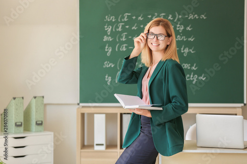 Beautiful female teacher in classroom