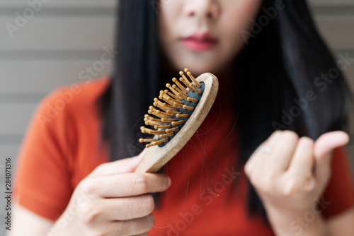 long loss hair on woman brush with and woman looking at her hair