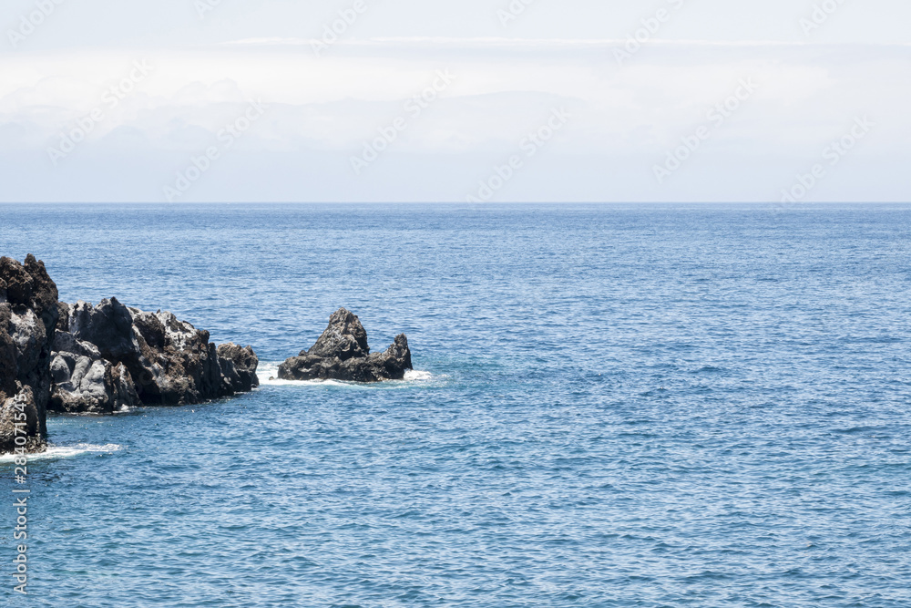 Beautiful blue sea with rocks on the coast
