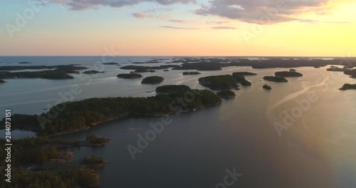 Aerial, tracking, drone shot over small islands, in the Finnish archipelago, on the Gulf of Finland, on a sunny, summer evening, in Tammisaaren saaristo national park, in Raasepori, Uusimaa, Suomi photo