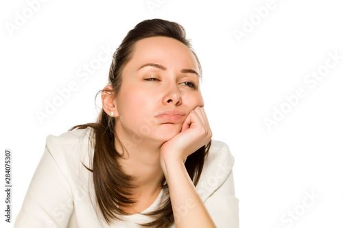 Bored sleepy woman with no makeup on white background