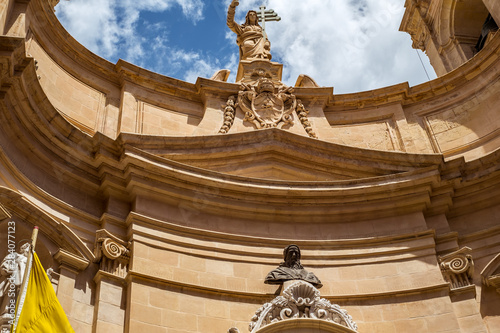 street with traditional balconies and old buildings in historical city Valletta Malta photo