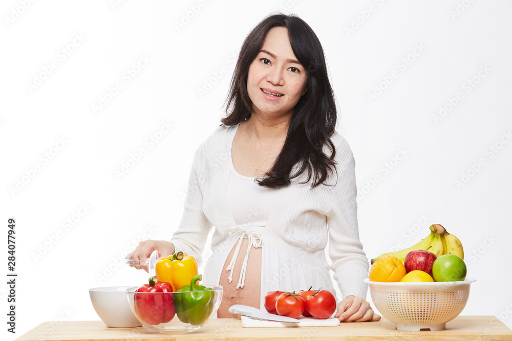 Belly women prepare food on the table.